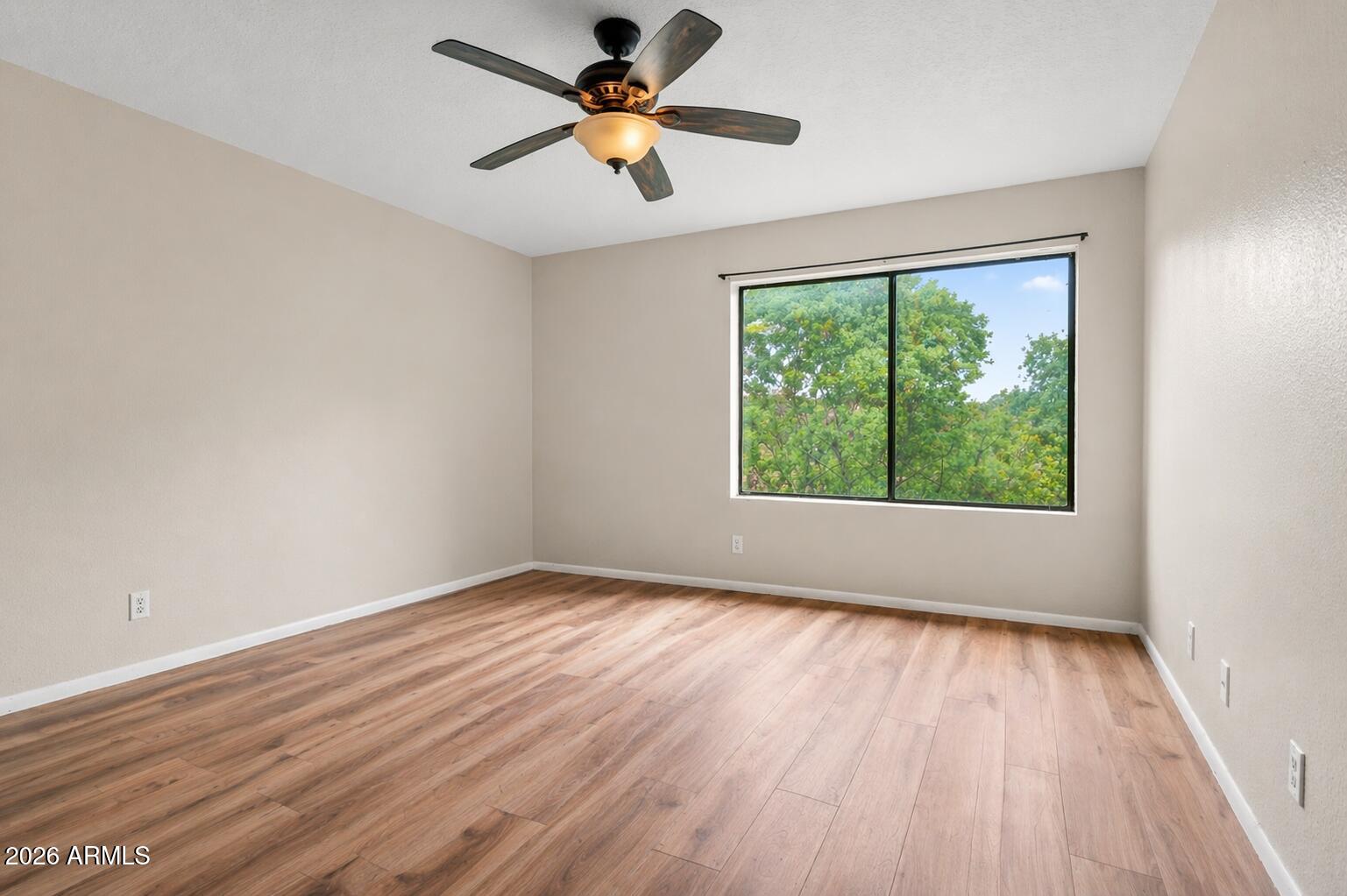65 Verde Valley School Road, Unit D15 Sedona, AZ 86351 - Photo 16 of 27 an empty room with wooden floor fan and windows