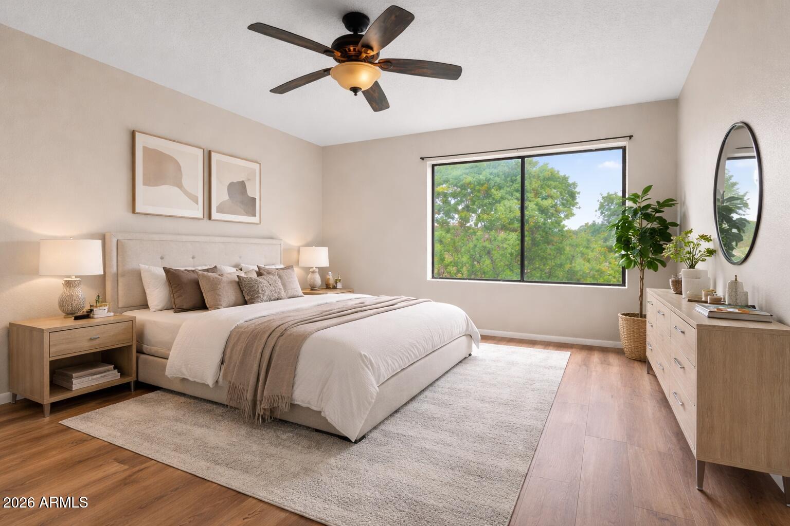 65 Verde Valley School Road, Unit D15 Sedona, AZ 86351 - Photo 17 of 27 a spacious bedroom with a large bed and a chandelier fan