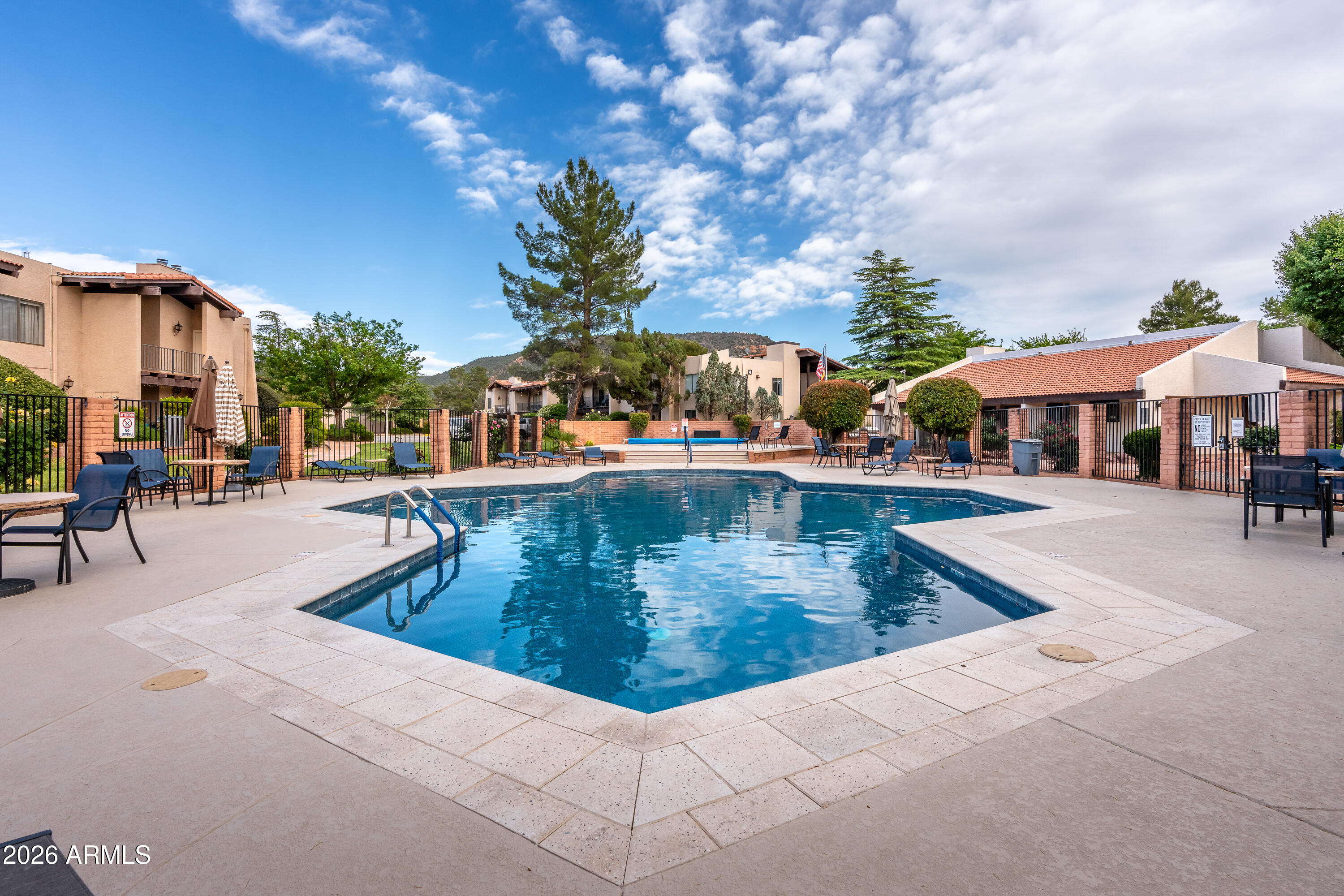 65 Verde Valley School Road, Unit D15 Sedona, AZ 86351 - Photo 25 of 27 a view of a swimming pool with outdoor seating