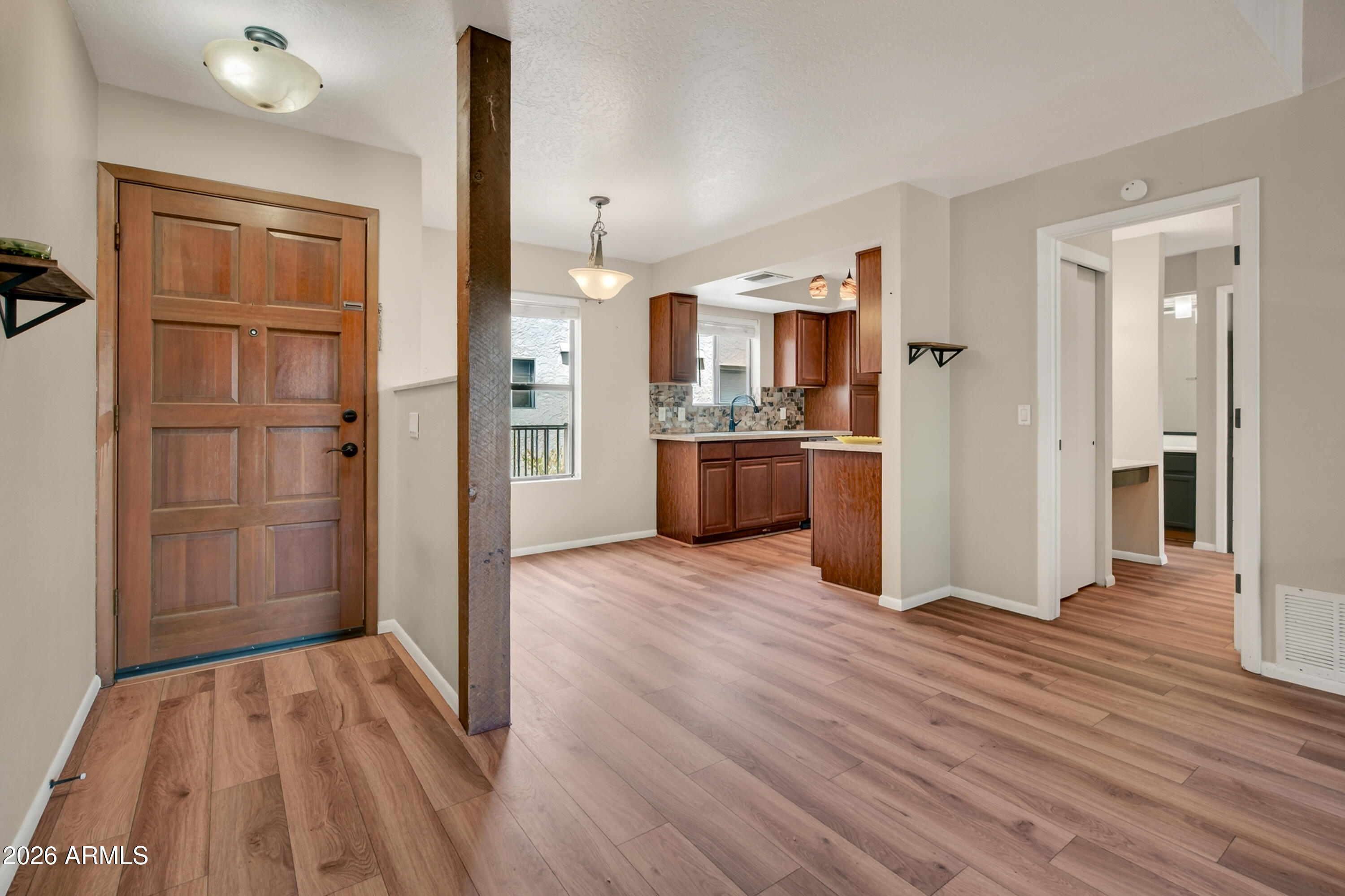 65 Verde Valley School Road, Unit D15 Sedona, AZ 86351 - Photo 4 of 27 a view of a kitchen with refrigerator and wooden floor