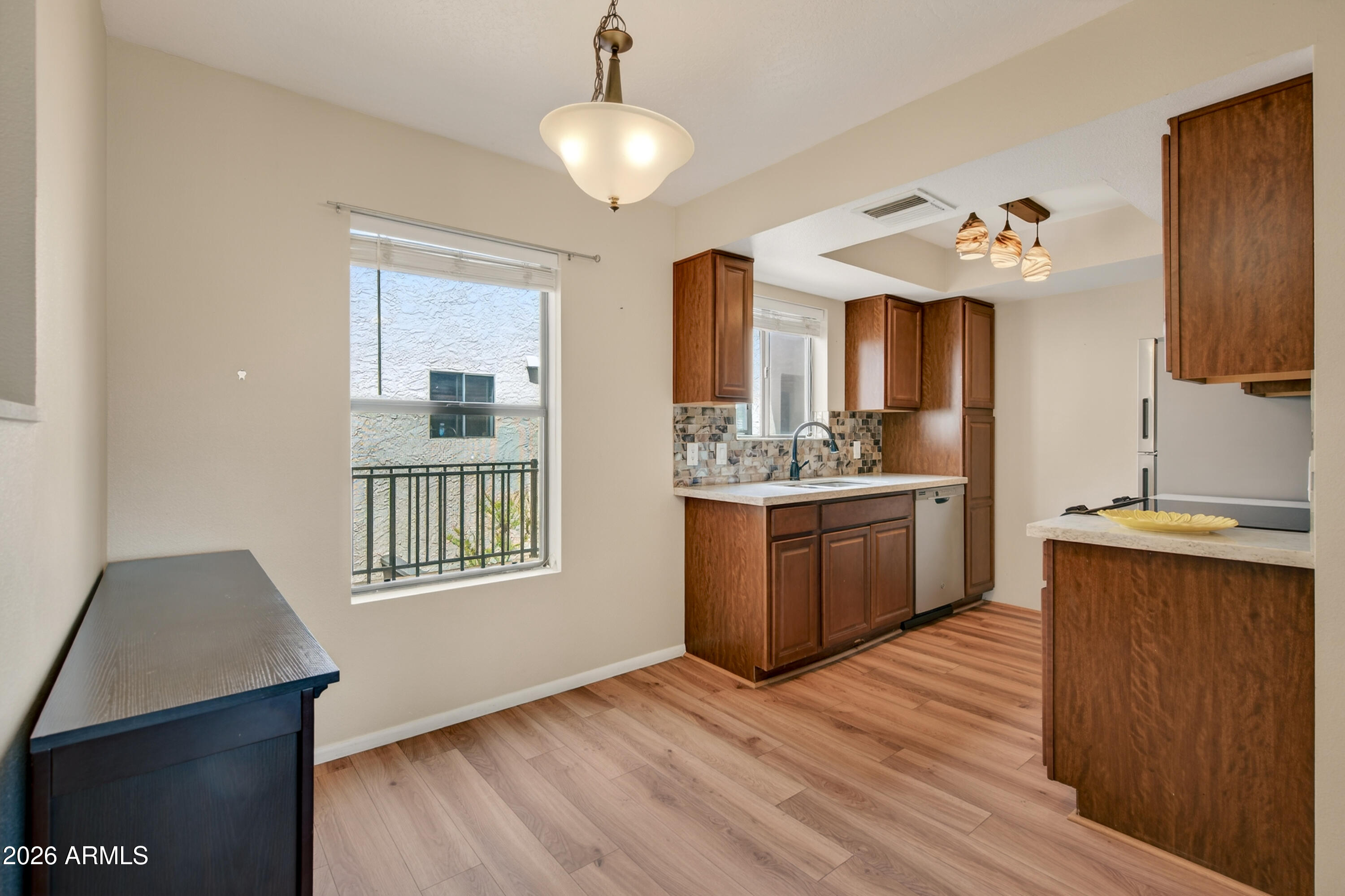 65 Verde Valley School Road, Unit D15 Sedona, AZ 86351 - Photo 5 of 27 a kitchen with stainless steel appliances granite countertop a sink dishwasher a stove and a refrigerator with wooden floor
