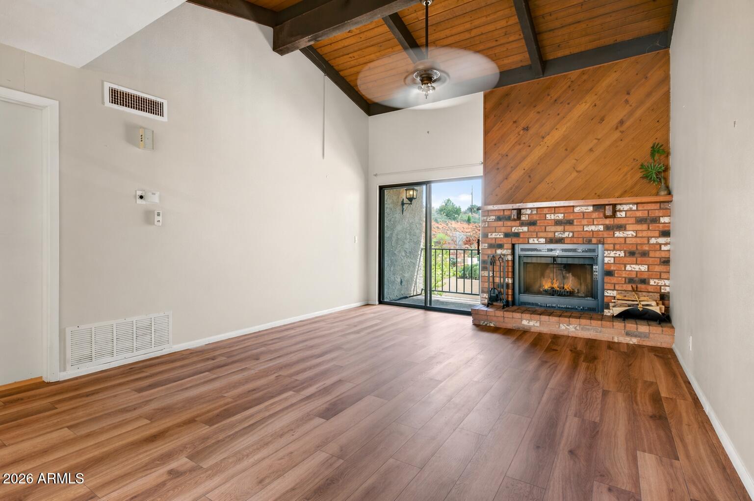 65 Verde Valley School Road, Unit D15 Sedona, AZ 86351 - Photo 10 of 27 a view of empty room with wooden floor and fireplace