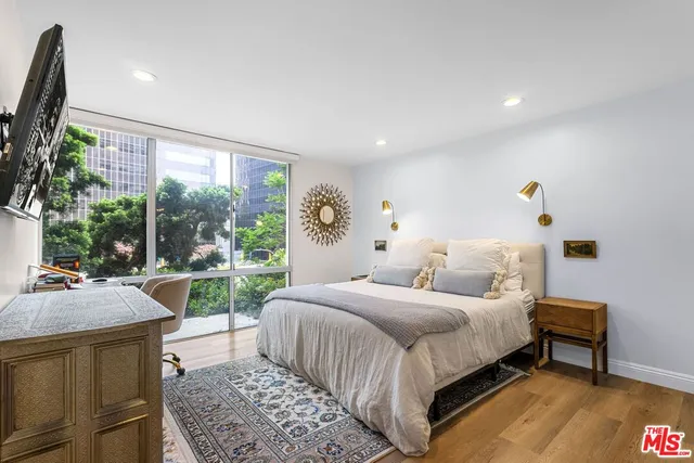 a bedroom with a bed and a large window