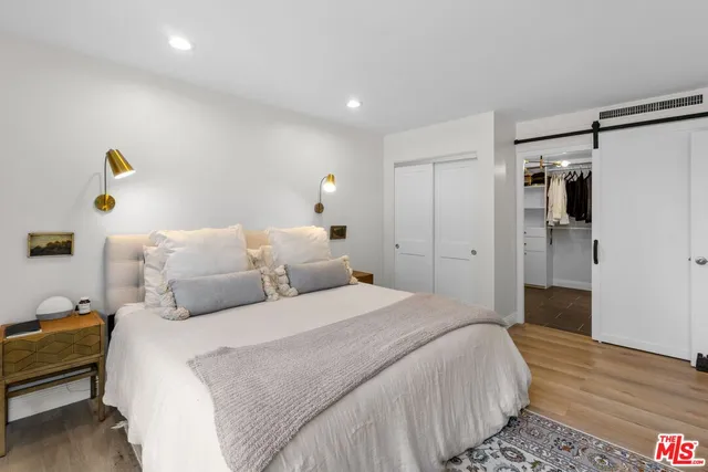 a bedroom with a bed and a walk in closet