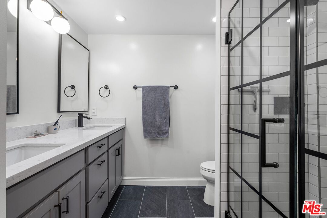 2160 Century Park East, Unit 211 Los Angeles, CA 90067 - Photo 15 of 24 a bathroom with a double vanity sink toilet and shower
