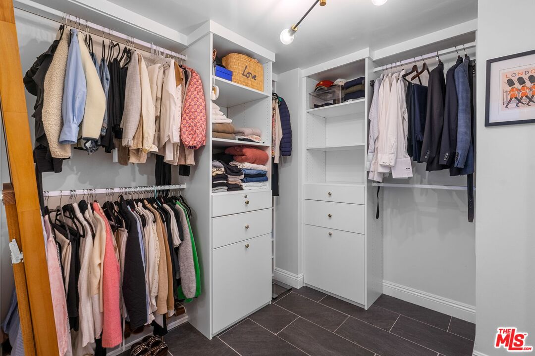 2160 Century Park East, Unit 211 Los Angeles, CA 90067 - Photo 17 of 24 a view of walk in closet with clothes and shoes
