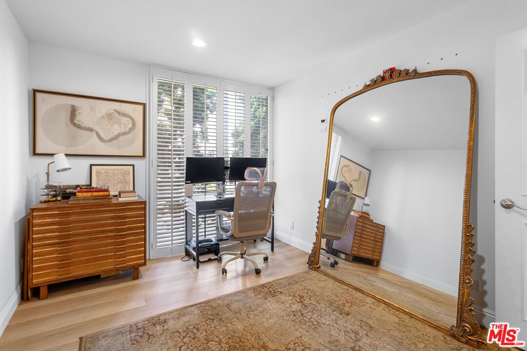 2160 Century Park East, Unit 211 Los Angeles, CA 90067 - Photo 18 of 24 a bedroom with furniture and a window