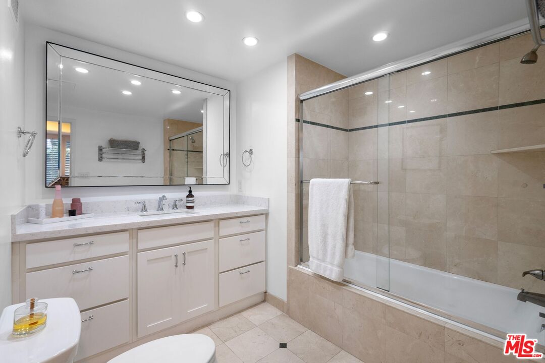 2160 Century Park East, Unit 211 Los Angeles, CA 90067 - Photo 19 of 24 a bathroom with a sink a toilet and shower