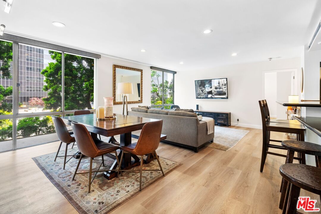 2160 Century Park East, Unit 211 Los Angeles, CA 90067 - Photo 5 of 24 a view of a dining room with furniture window and wooden floor