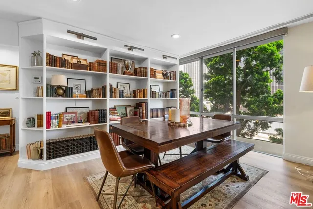 a room with stainless steel appliances a table and chairs in it