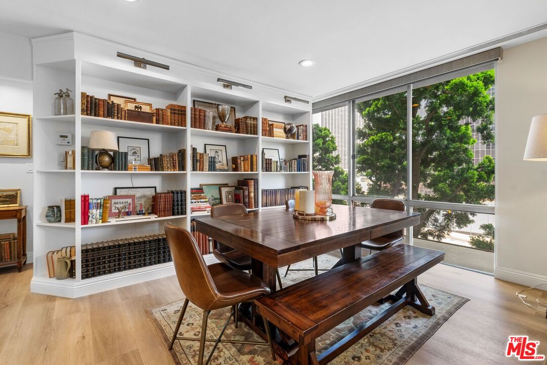 2160 Century Park East, Unit 211 Los Angeles, CA 90067 - Photo 6 of 24 a room with stainless steel appliances a table and chairs in it