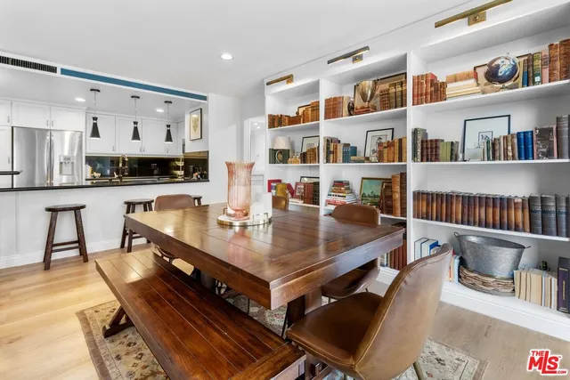 a living room with furniture and a book shelf