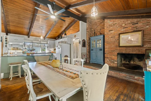 a dining room with furniture and wooden floor