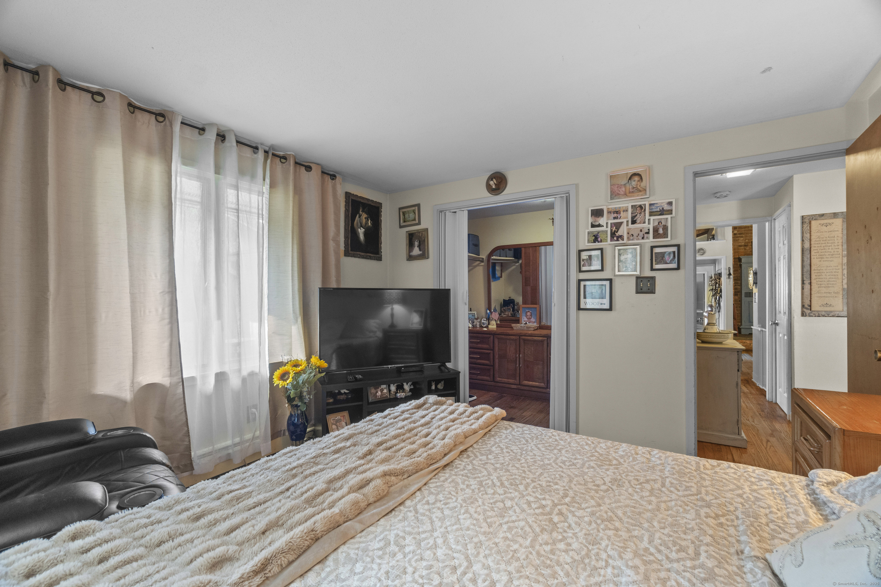 92 Minortown Road Woodbury, CT 06798 - Photo 15 of 40 a bedroom with a bed and a flat screen tv