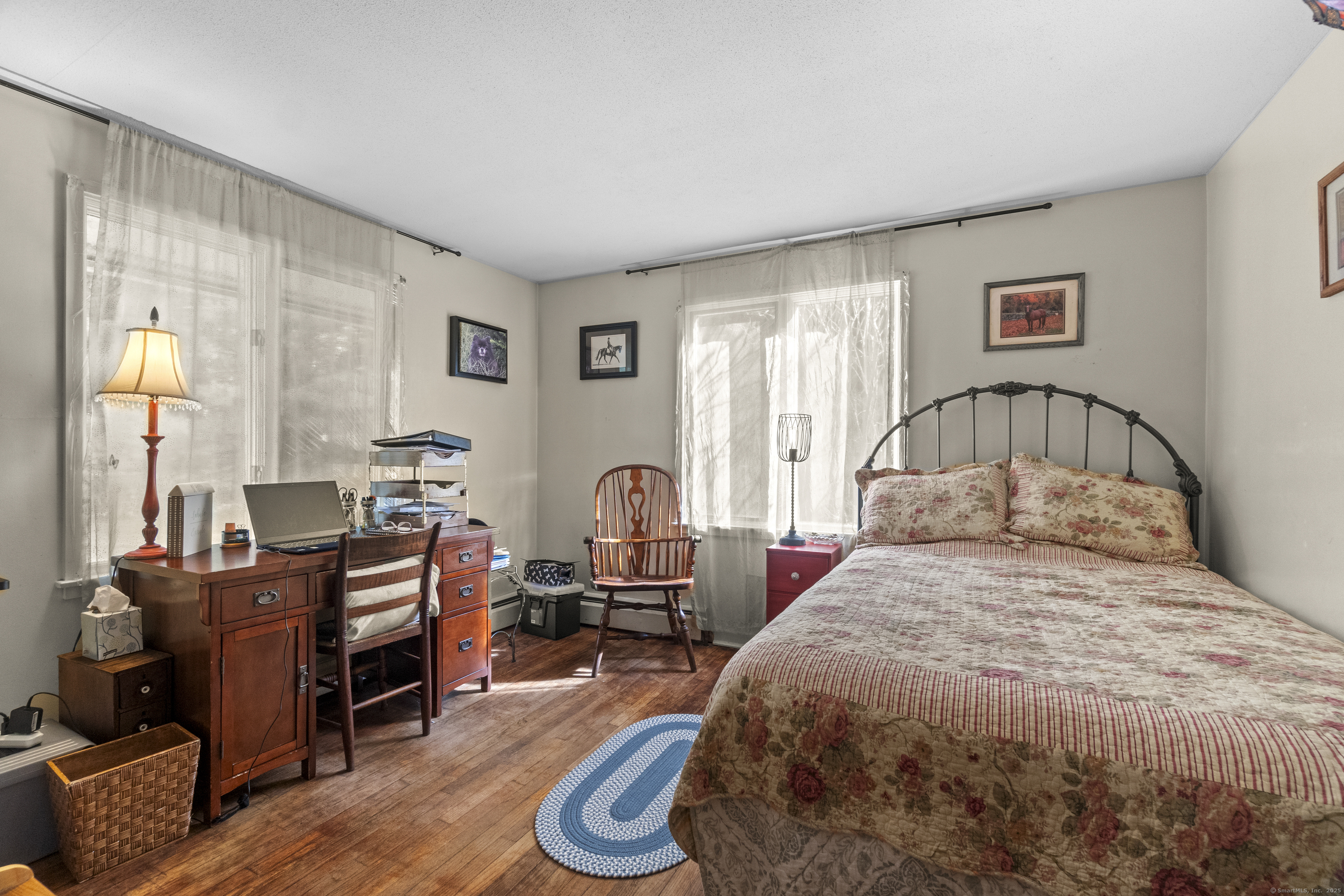 92 Minortown Road Woodbury, CT 06798 - Photo 16 of 40 a bedroom with a bed and wooden floor