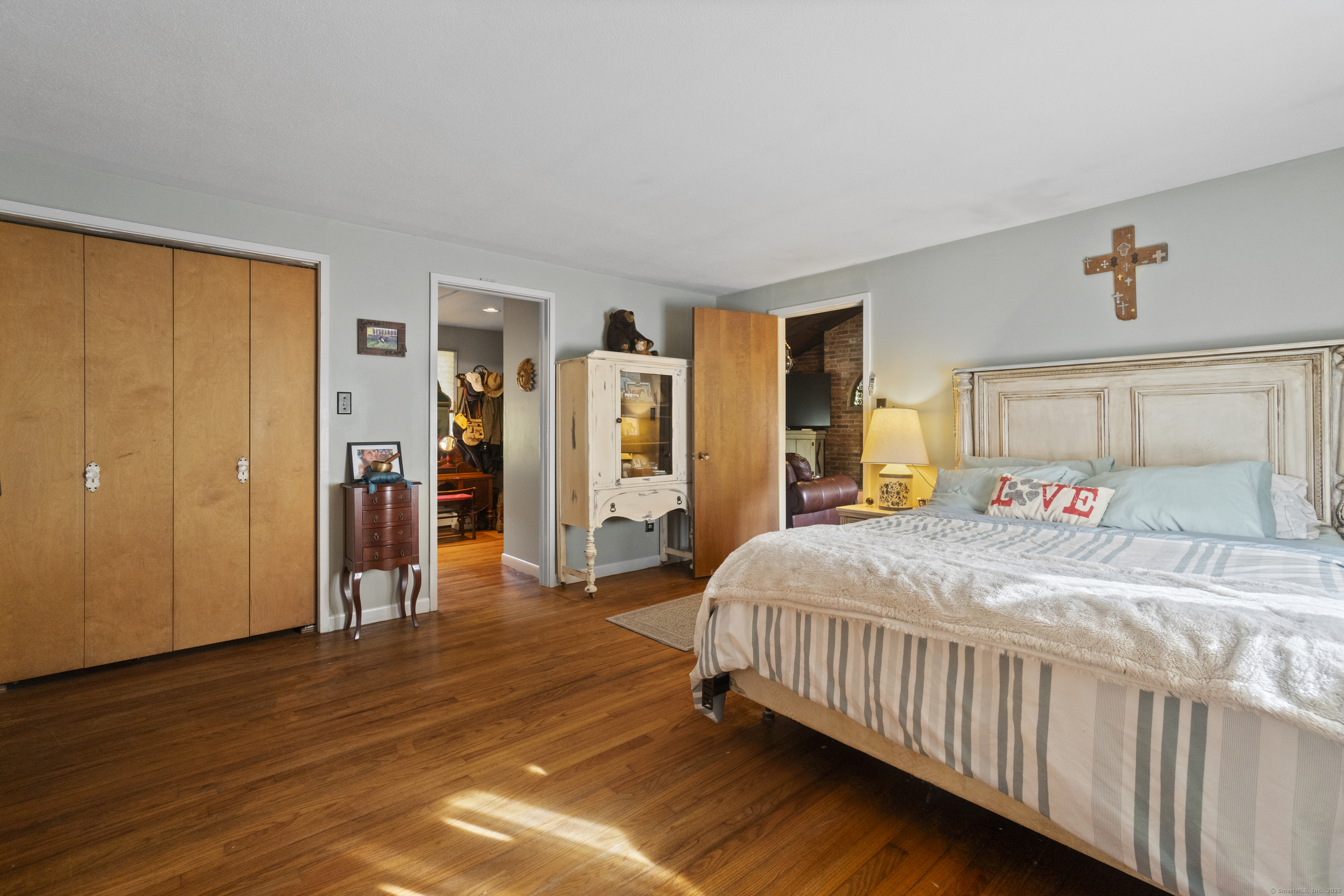 92 Minortown Road Woodbury, CT 06798 - Photo 18 of 40 a bedroom with a bed and wooden floor