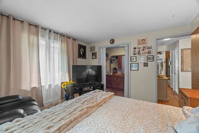 a bedroom with a bed and a flat screen tv