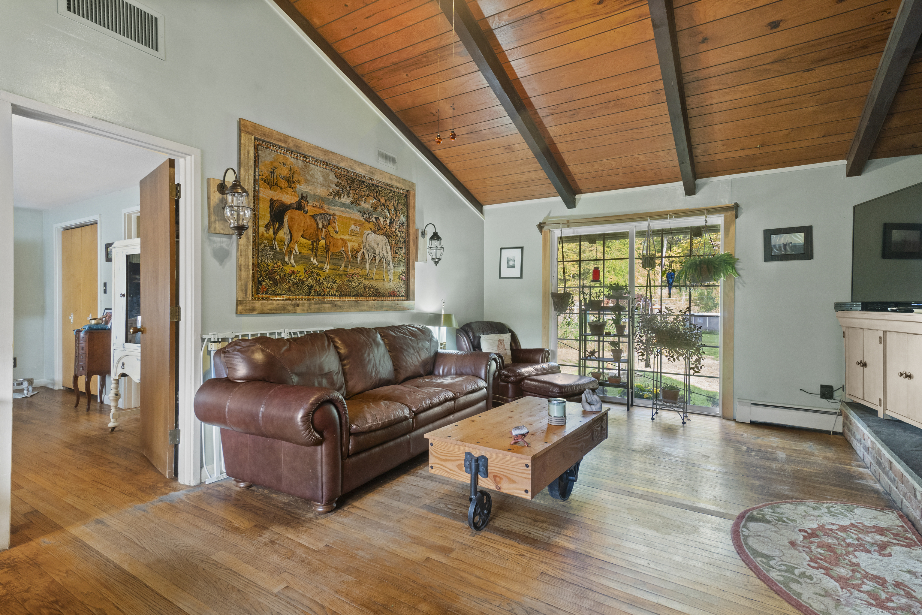 92 Minortown Road Woodbury, CT 06798 - Photo 20 of 40 a living room with furniture a wooden floor and a large window