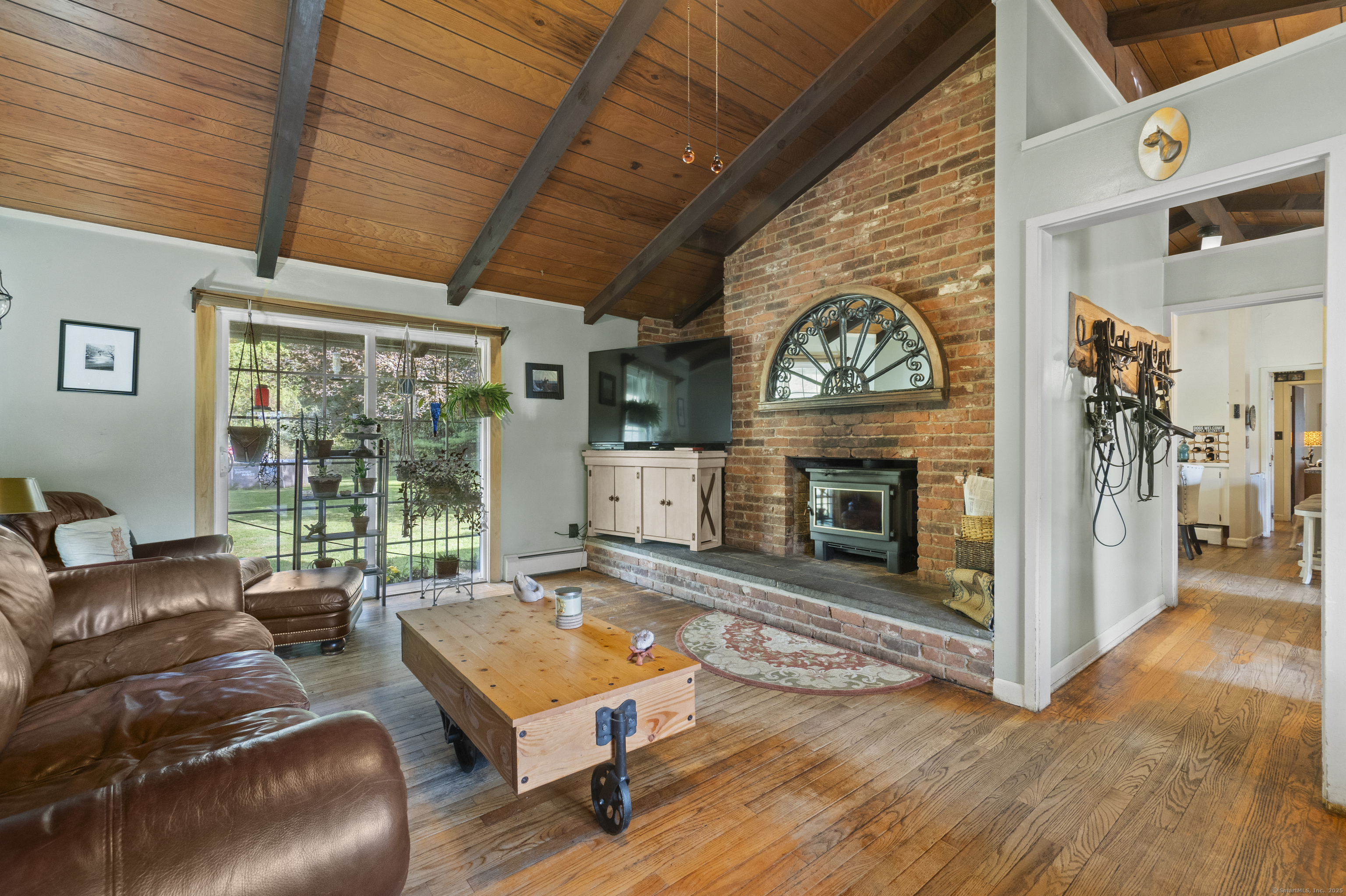 92 Minortown Road Woodbury, CT 06798 - Photo 21 of 40 a living room with furniture fireplace and a large window