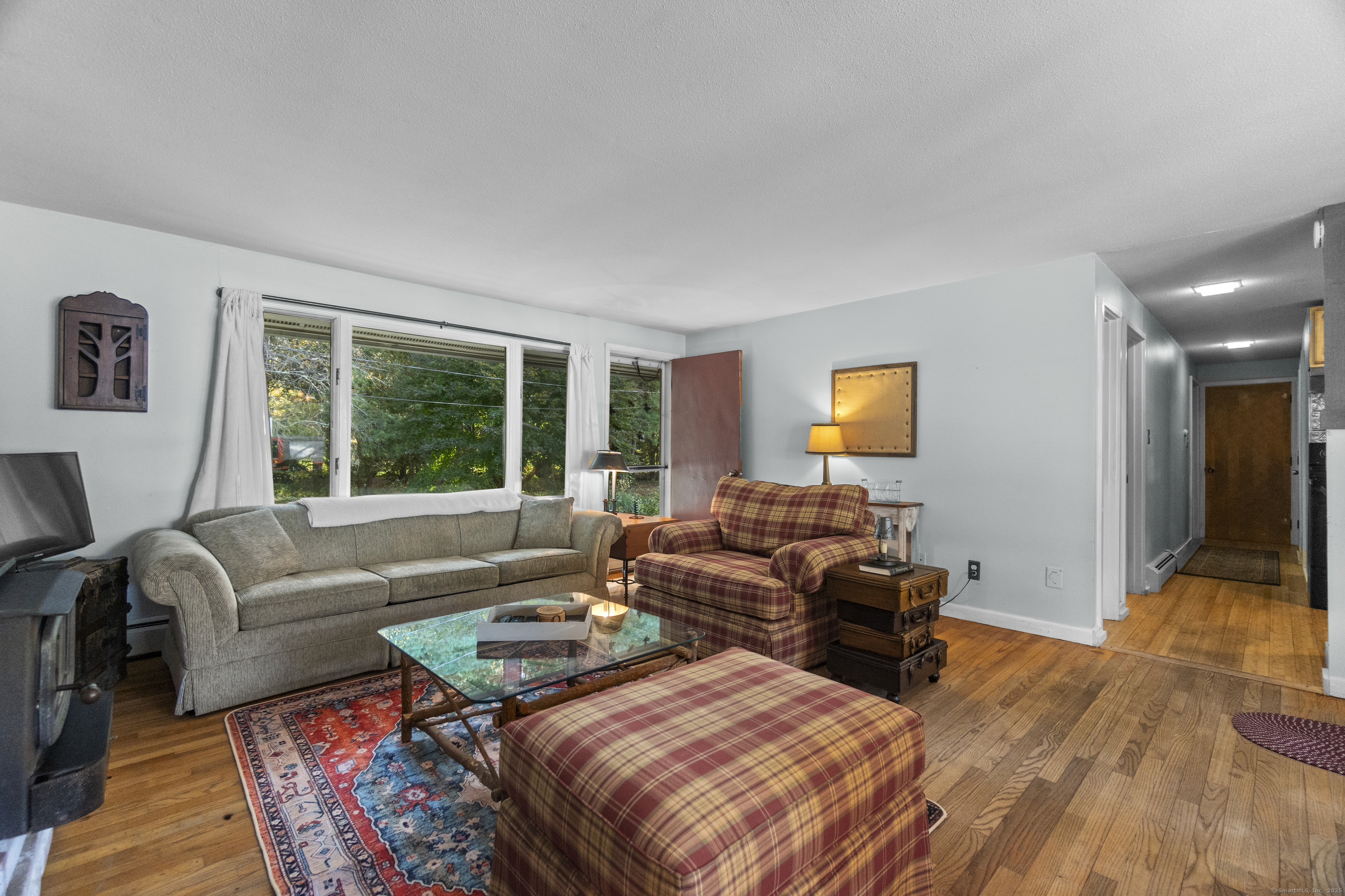 92 Minortown Road Woodbury, CT 06798 - Photo 27 of 40 a living room with furniture and a large window