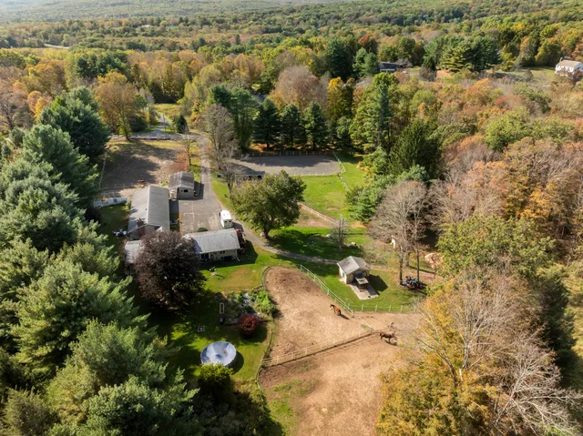 an aerial view of a house with a yard and lake view