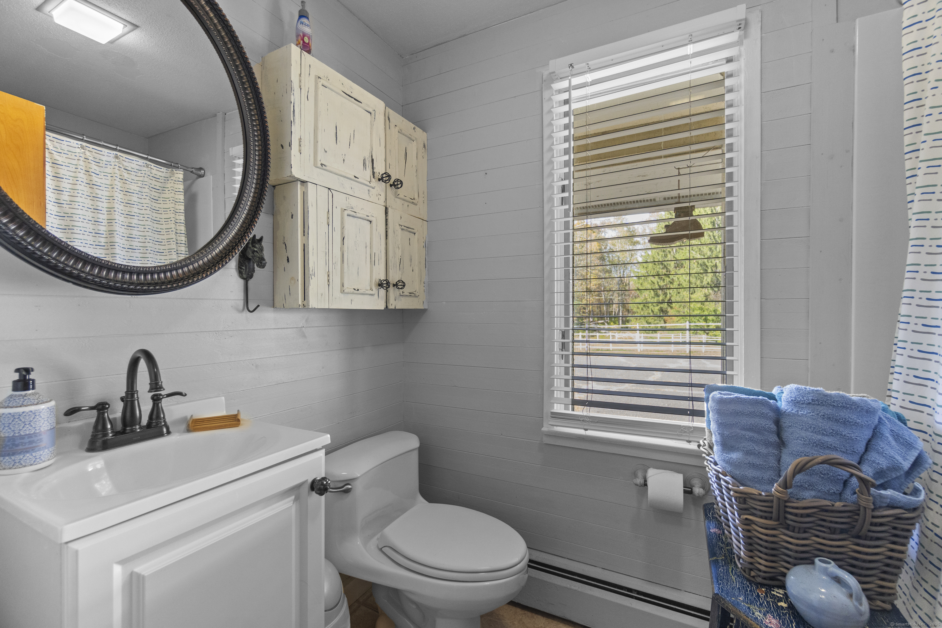 92 Minortown Road Woodbury, CT 06798 - Photo 31 of 40 a bathroom with a toilet a sink and mirror