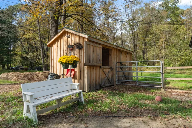 a view of a backyard with wooden fence