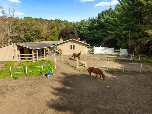 a view of a house with pool and a yard