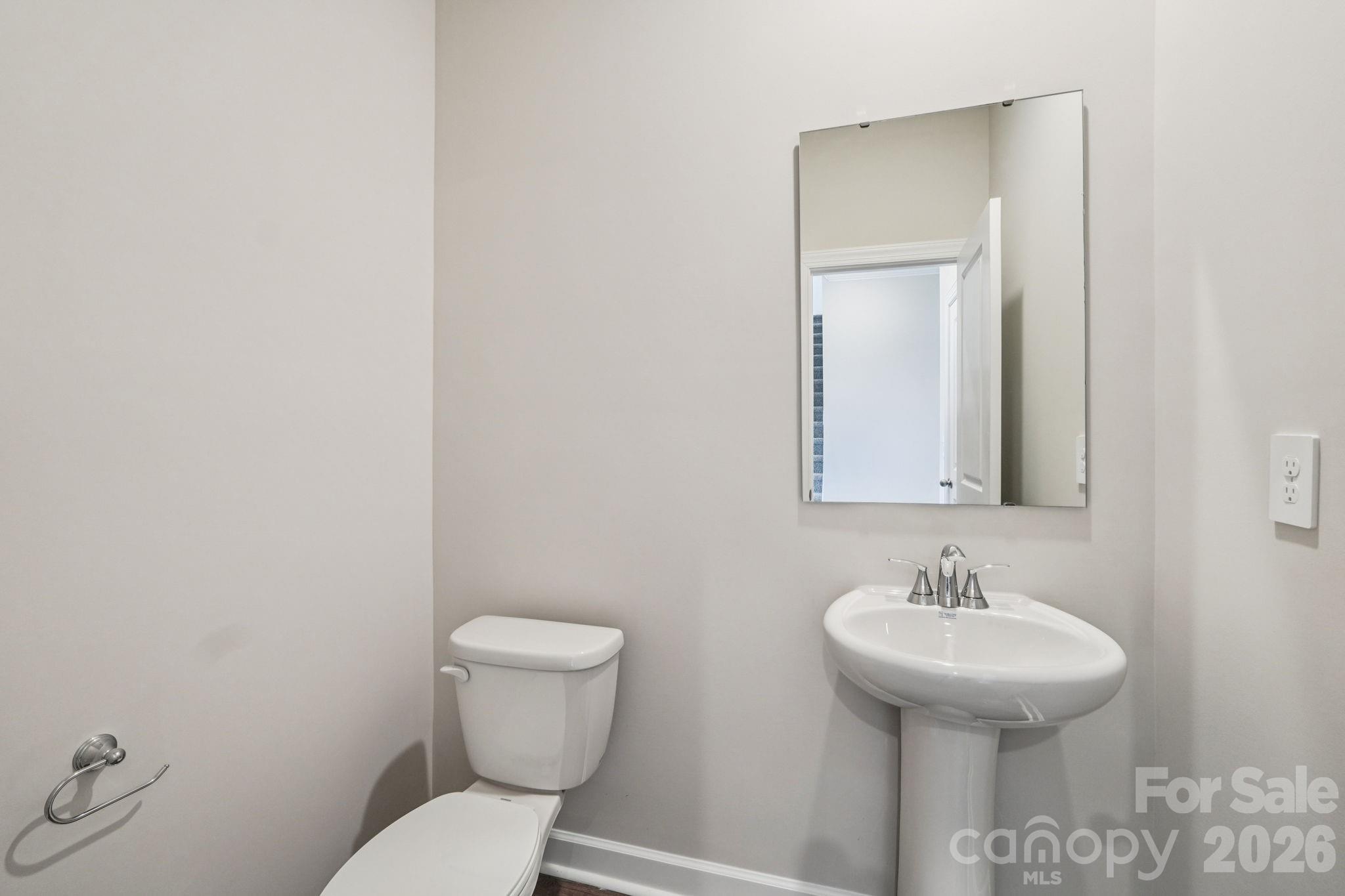 2452 Chartwell Street Stanley, NC 28164 - Photo 7 of 15 a bathroom with a toilet sink and mirror