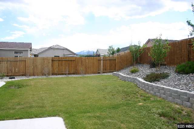 1251 Edgehill Court Reno, NV 89521 - Photo 3 of 6 a view of a backyard with large trees