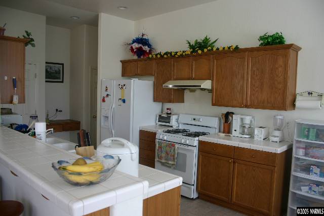 1251 Edgehill Court Reno, NV 89521 - Photo 5 of 6 a kitchen with a sink stove and cabinets