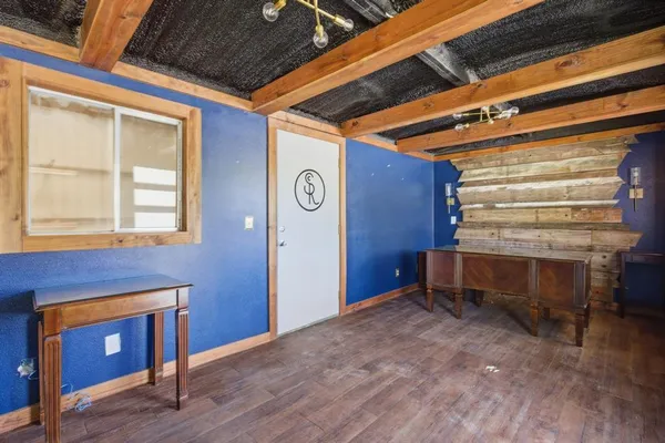 a room with a table chair and windows