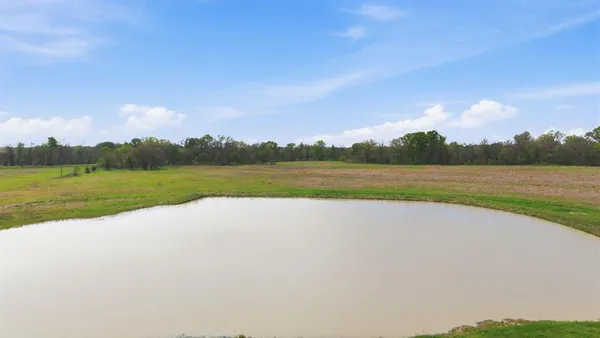 a view of a field with an ocean