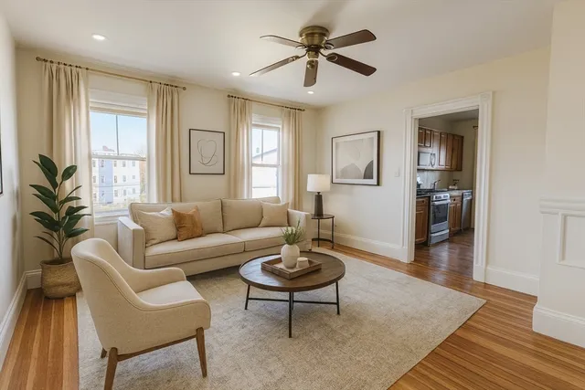 a living room with furniture a window and a chandelier