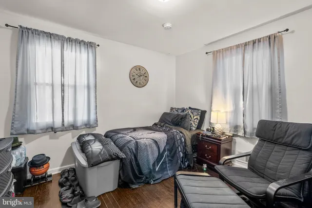 a bedroom with furniture and a large window