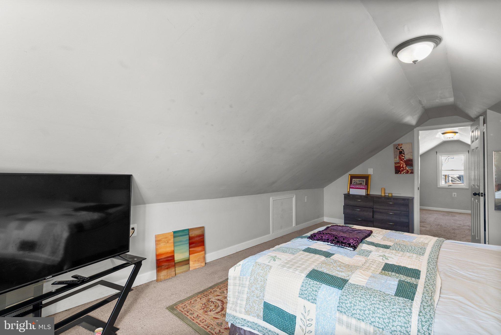 5122 Decatur Street Hyattsville, MD 20781 - Photo 18 of 22 a bedroom with a bed and a flat screen tv