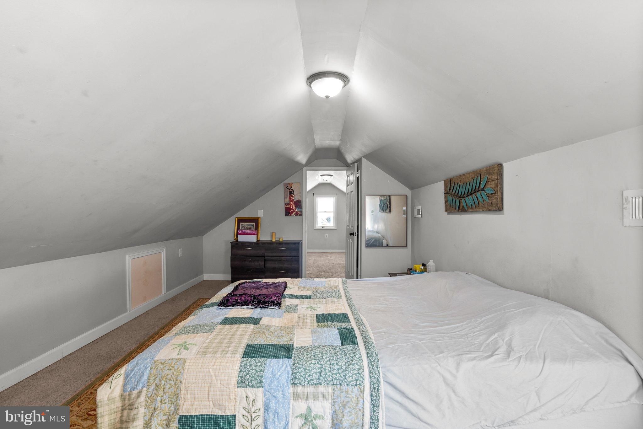 5122 Decatur Street Hyattsville, MD 20781 - Photo 19 of 22 a bedroom with a bed and a chandelier