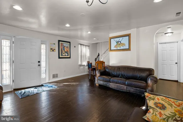a living room with hard wood floors and a couch