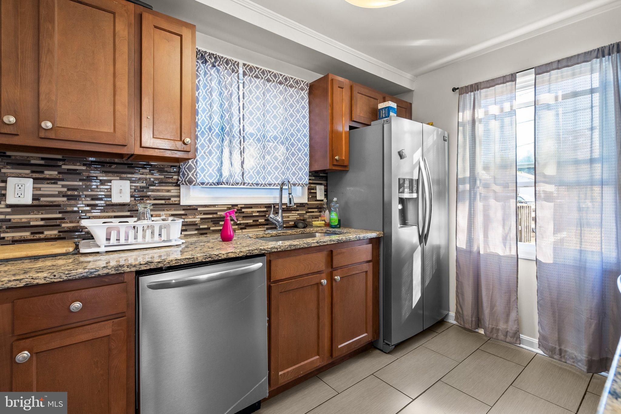 5122 Decatur Street Hyattsville, MD 20781 - Photo 7 of 22 a kitchen with stainless steel appliances granite countertop a refrigerator and a sink