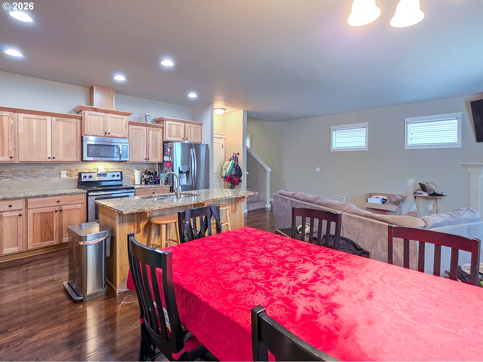 2838 26th Avenue Forest Grove, OR 97116 - Photo 12 of 37 a kitchen with stainless steel appliances kitchen island granite countertop a dining table chairs and view kitchen
