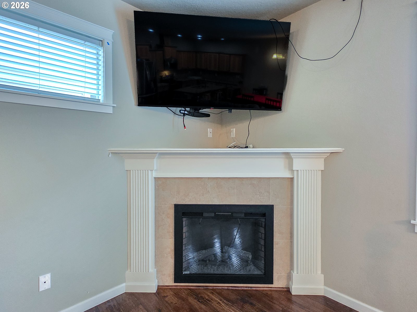 2838 26th Avenue Forest Grove, OR 97116 - Photo 5 of 37 a living room with a fireplace a flat screen tv and a window