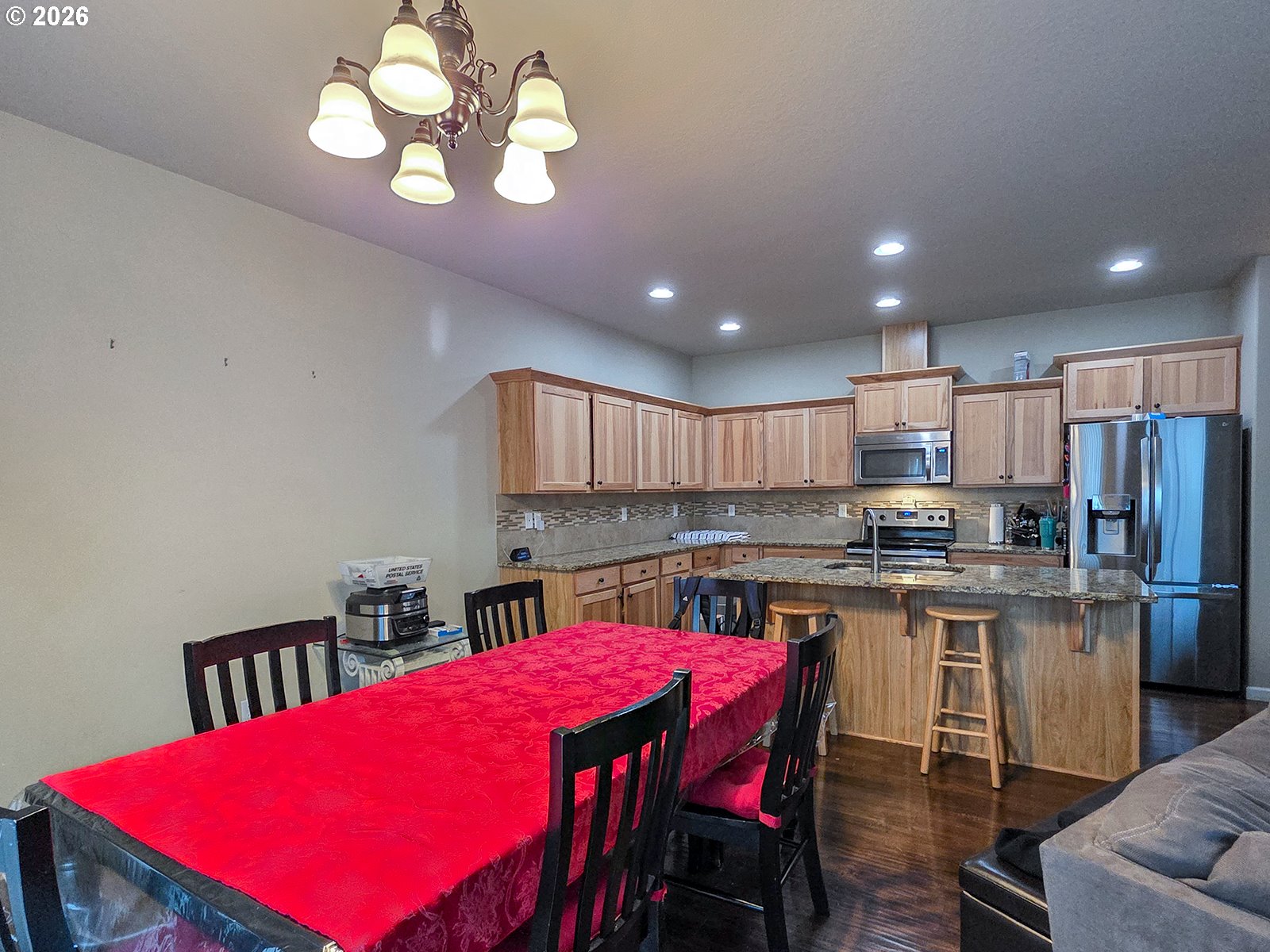 2838 26th Avenue Forest Grove, OR 97116 - Photo 6 of 37 a kitchen with kitchen island a stove a table a sink cabinets and a dining table