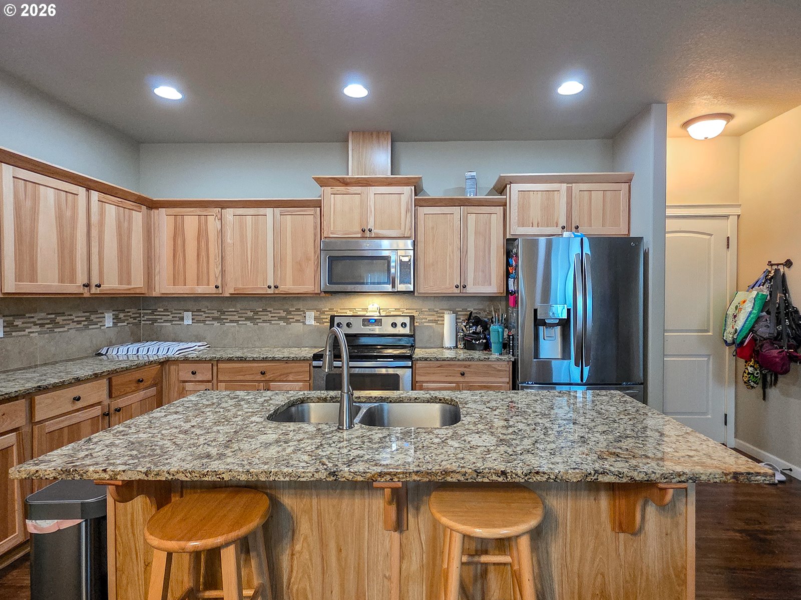 2838 26th Avenue Forest Grove, OR 97116 - Photo 7 of 37 a kitchen with stainless steel appliances granite countertop a sink refrigerator and cabinets