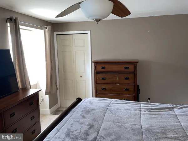 a room with a dresser and a flat screen tv