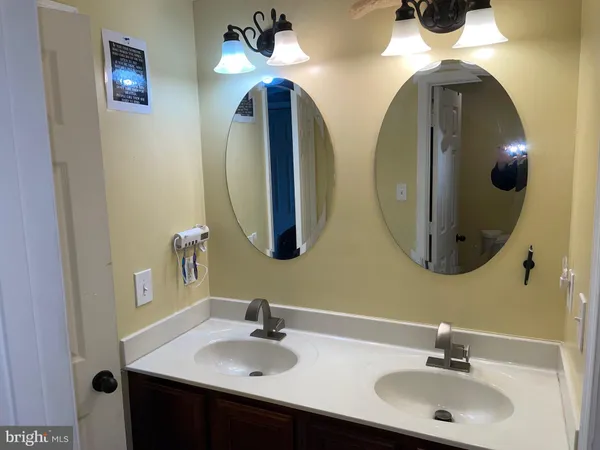 a bathroom with a double vanity sink and a mirror