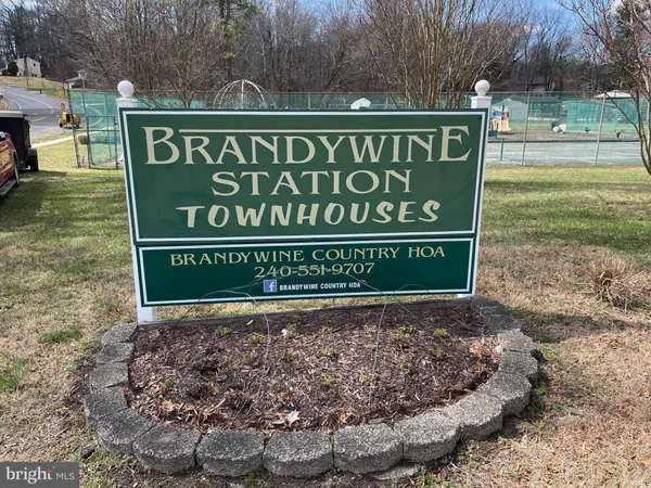 a sign broad in front of the red brick house