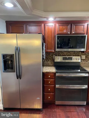 a kitchen with a refrigerator and a sink