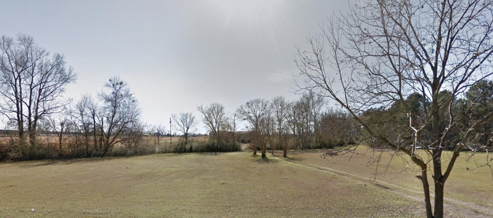 1700 Mt Olive Road Dublin, GA 31021 - Photo 1 of 1 a view of a yard covered with snow in front of house