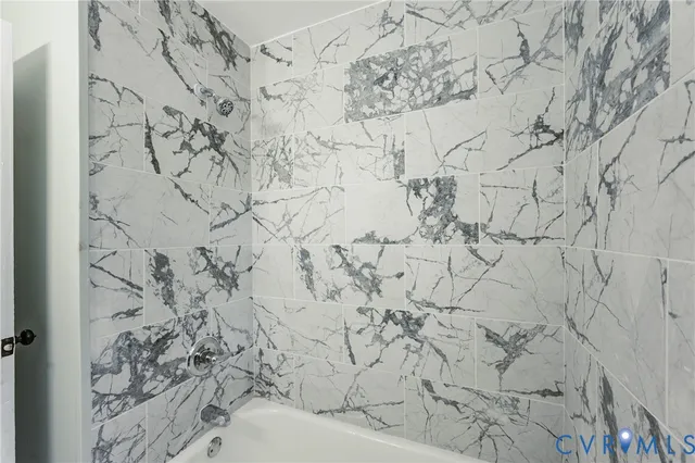 a bathroom with a bathtub and shower