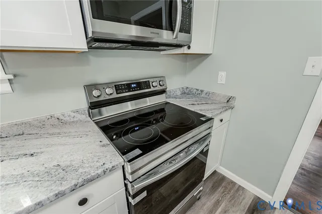 a stove top oven sitting inside of a kitchen